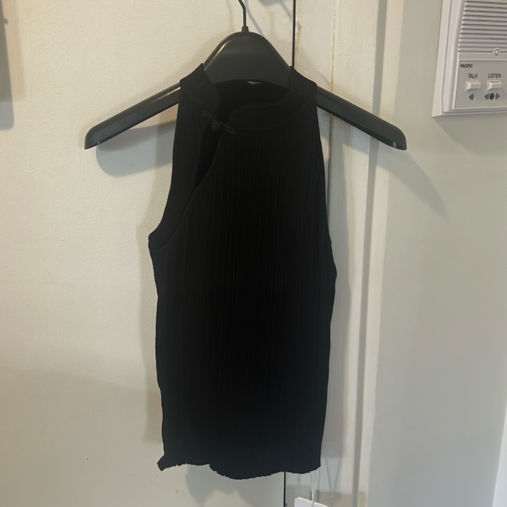 Elegant black sleeveless top with high neck, never worn